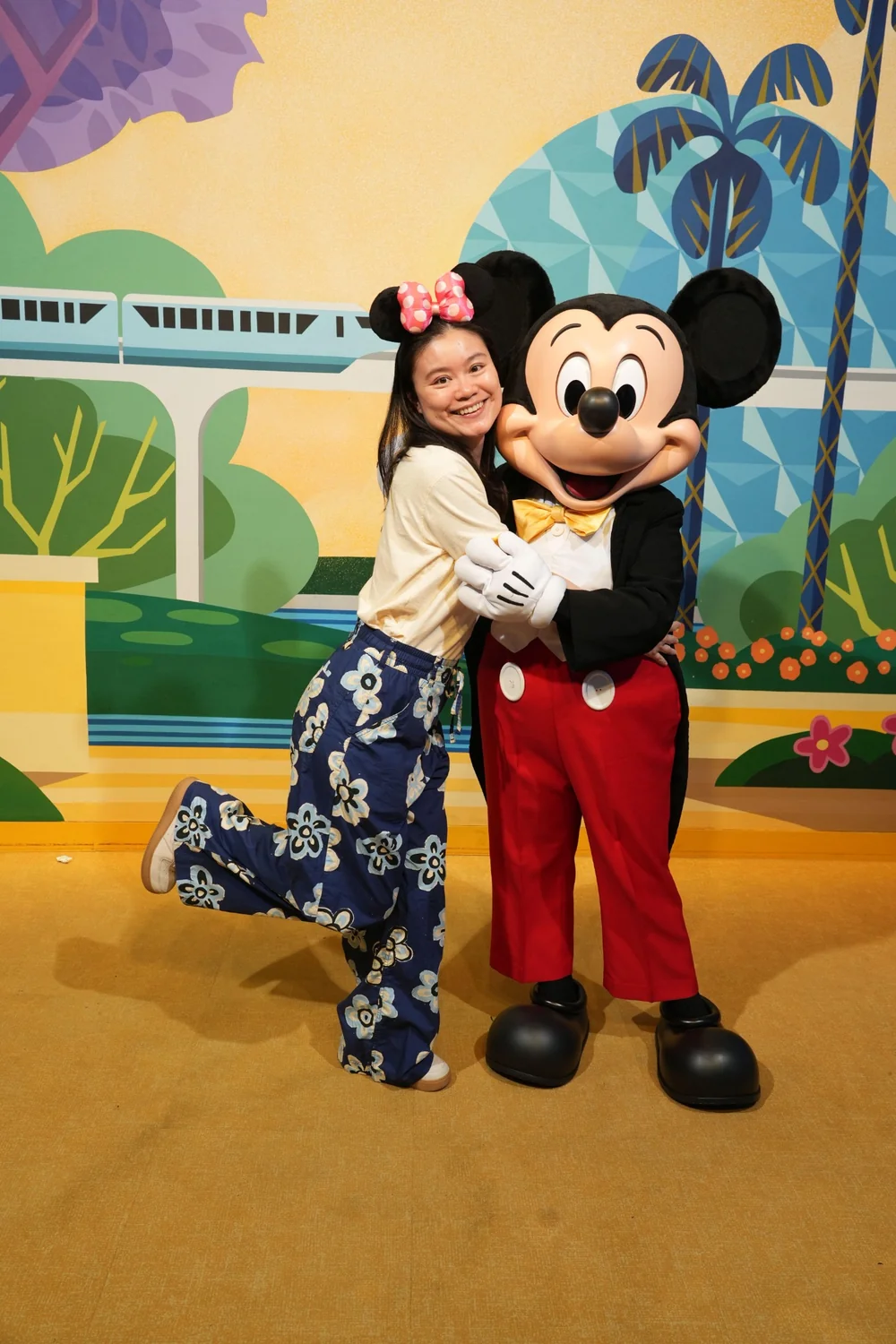 Lin smiling for a playful photo at a theme park